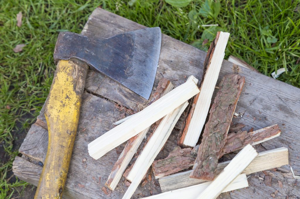 chopping firewood into chips with an ax