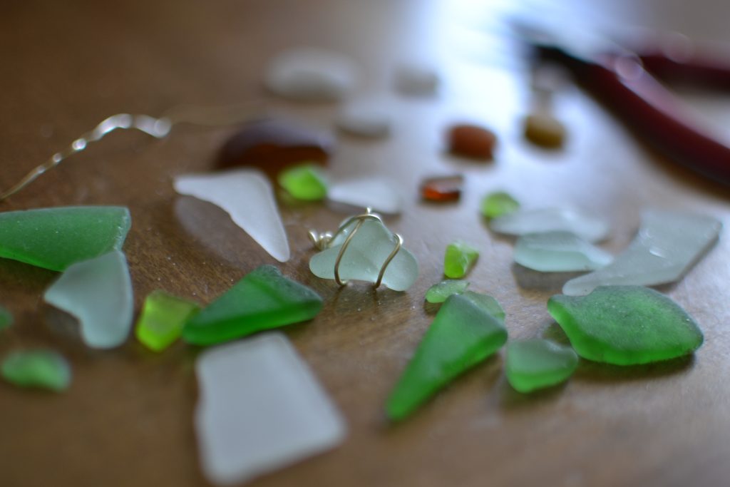 Making jewelry out of green seaglass, sea glass. Crafting, DIY hobby, hobbies
